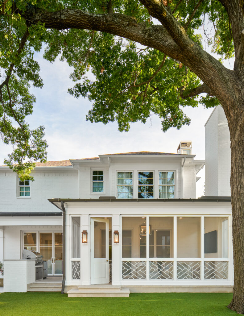 Custom patio with wood accent screens and white farmhouse styled porch made by Gillis custom homes in dallas texas