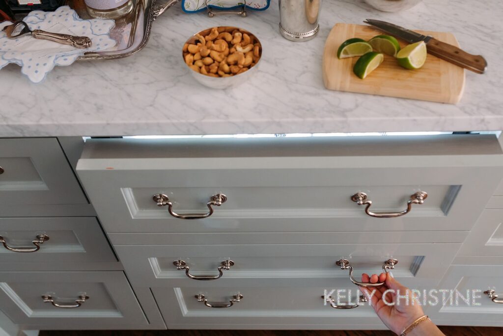 Recent project of a luxury custom home with a client chosen hand crafted cabinets, light blue painted trim over a beautiful bar with a built in drawer fridge or refrigerated drink drawer built by Gillis Custom Homes in Dallas Texas